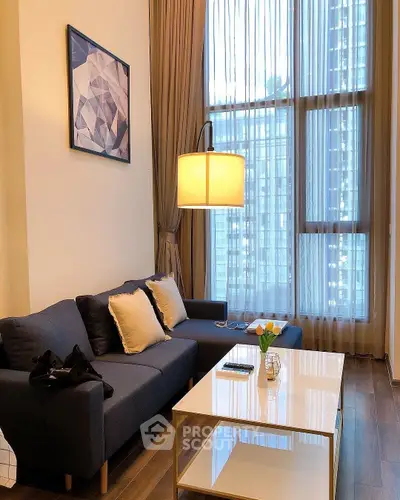 Modern living room with high ceilings and large windows offering city views.