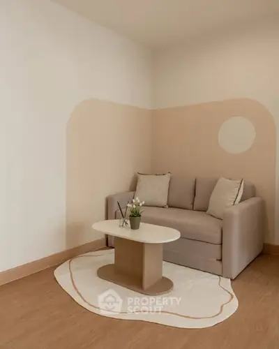 Cozy living room with modern beige sofa and stylish coffee table on wooden floor.