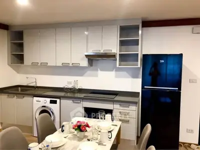 Modern kitchen with sleek cabinets, appliances, and dining area for stylish living.