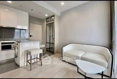 Modern living room with sleek kitchen and cozy seating area