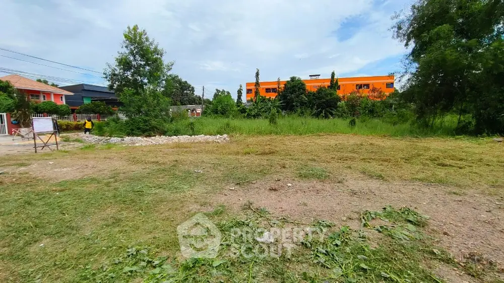 Spacious vacant land plot with lush greenery, ideal for development in a serene neighborhood.