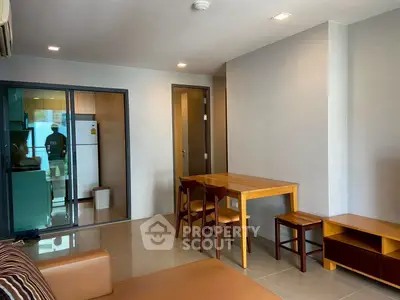 Modern living room with dining area and kitchen view in a stylish apartment.