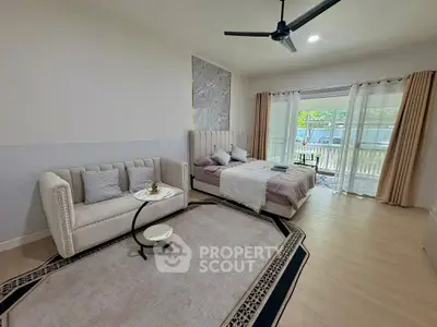 Spacious bedroom with elegant decor and balcony view