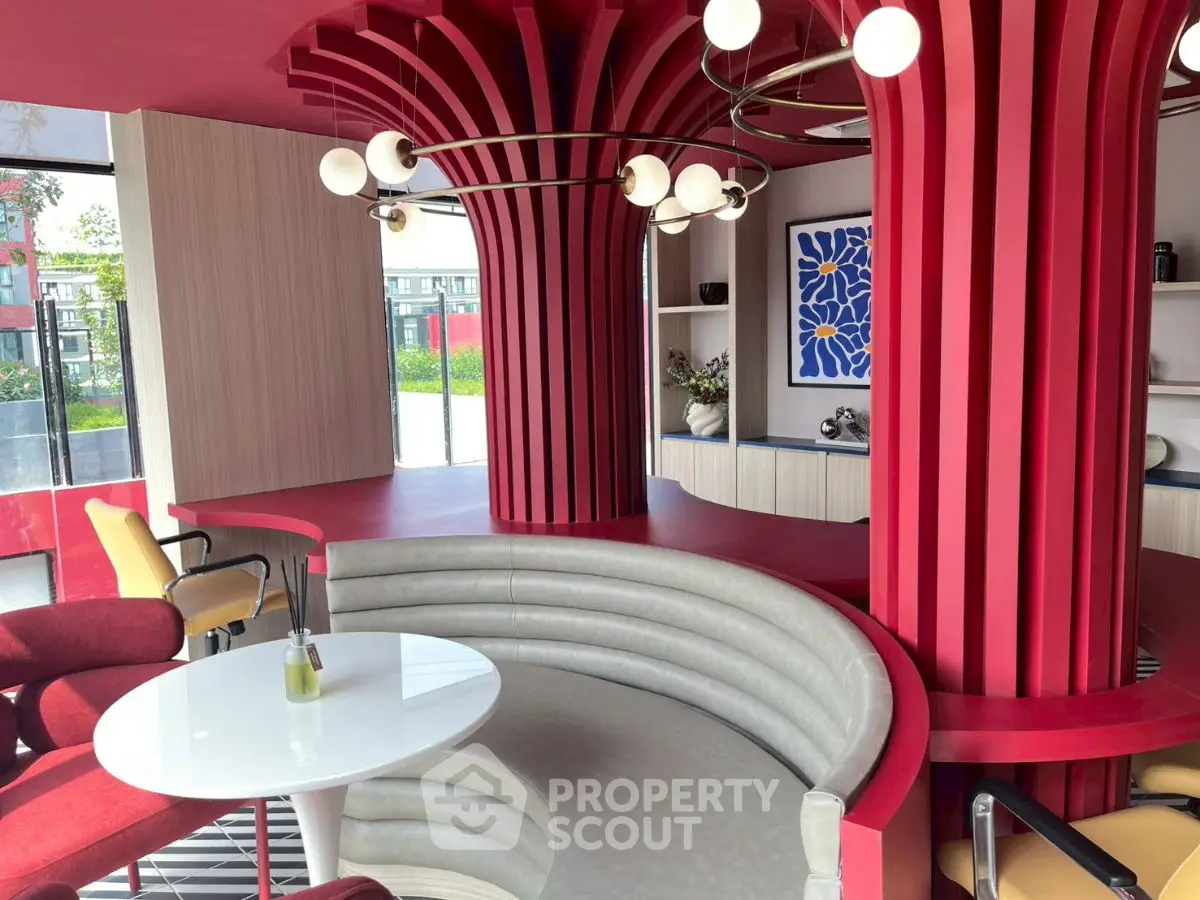 Modern interior with bold red columns and stylish seating area, perfect for contemporary living spaces.