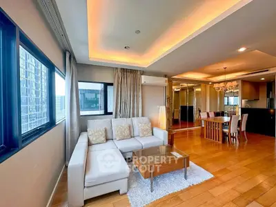 Spacious modern living room with elegant dining area and city view.