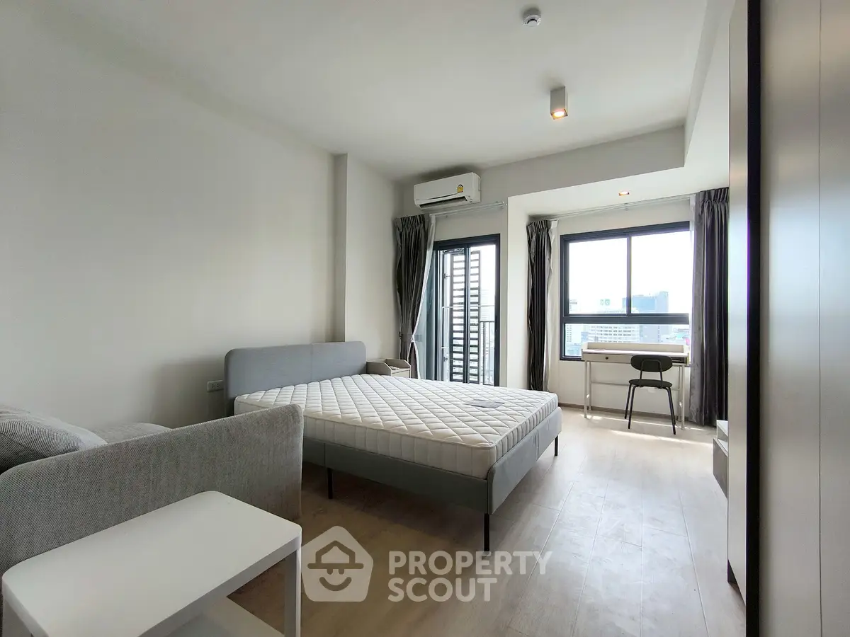 Spacious modern bedroom with large windows and stylish furnishings