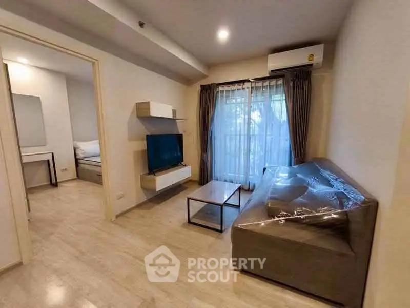 Modern living room with sleek furniture and natural light, perfect for cozy relaxation.