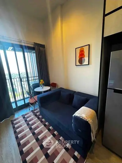Modern living room with cozy sofa, stylish decor, and balcony view in a high-rise apartment.