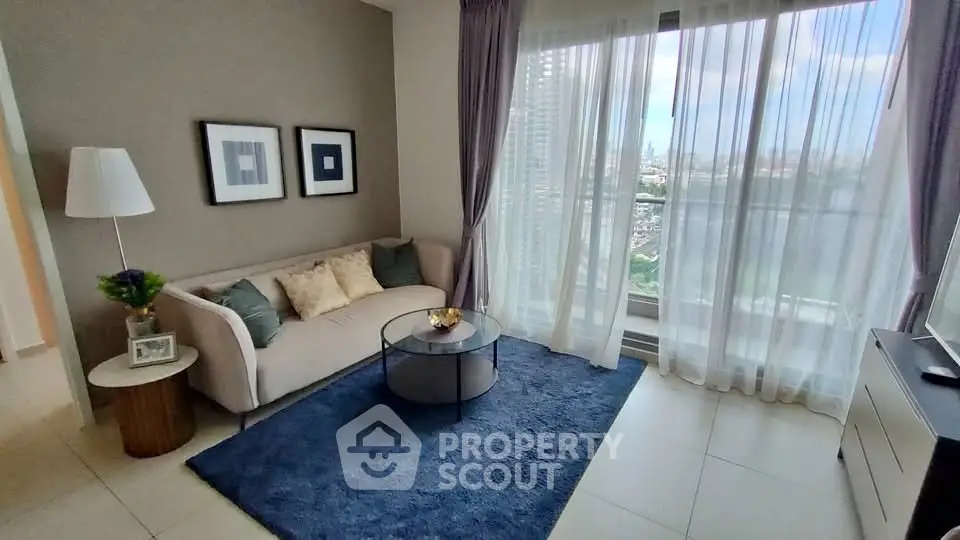 Modern living room with large window and city view, featuring cozy sofa and stylish decor.