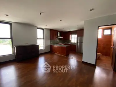 Spacious open layout kitchen with wooden flooring and modern appliances