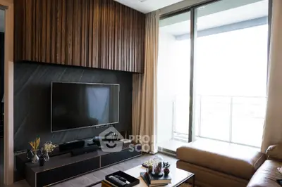 Modern living room with sleek TV setup and balcony view
