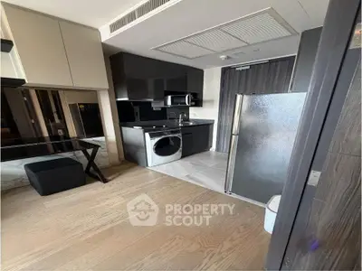 Modern kitchen with sleek appliances and stylish design in a contemporary apartment.