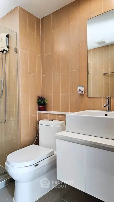 Modern bathroom with sleek fixtures and wooden tile accents