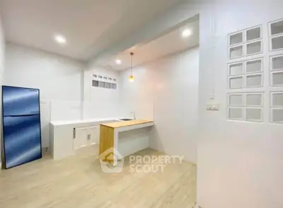 Modern minimalist kitchen with sleek design and blue fridge