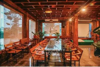 Stunning rustic dining area with wooden decor and large glass table, perfect for gatherings.