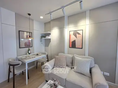 Modern living room with cozy sofa and dining area, featuring stylish decor and ambient lighting.