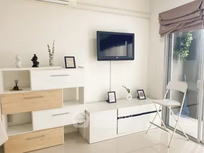 Modern living room with minimalist decor and wall-mounted TV