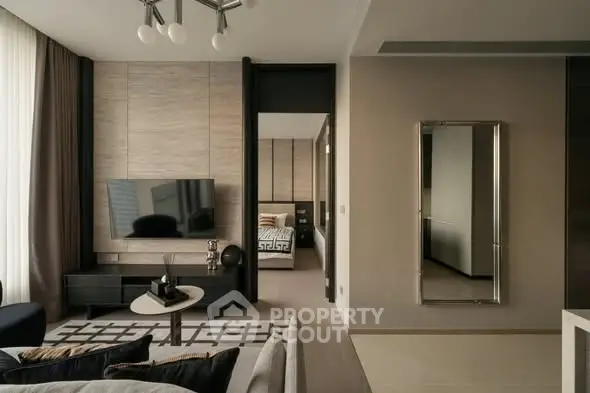 Modern living room with sleek design and open view to bedroom