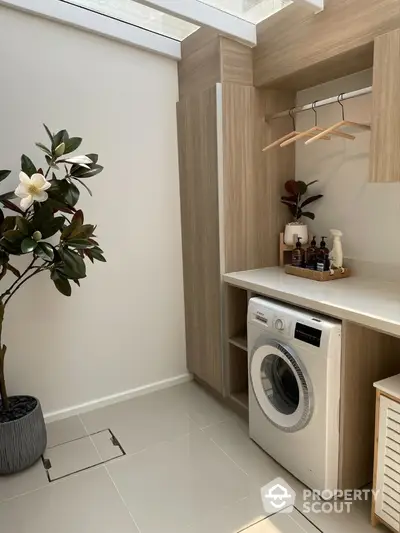 Modern laundry room with washing machine and stylish storage solutions