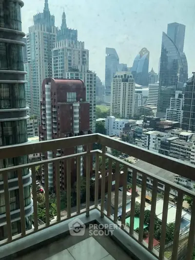 Stunning cityscape view from a high-rise balcony in a modern urban setting.
