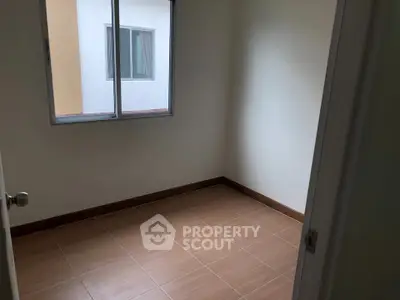 Minimalist empty room with tiled floor and window, perfect for customization.