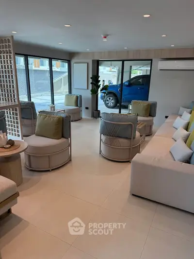 Spacious modern living room with stylish furniture and large windows