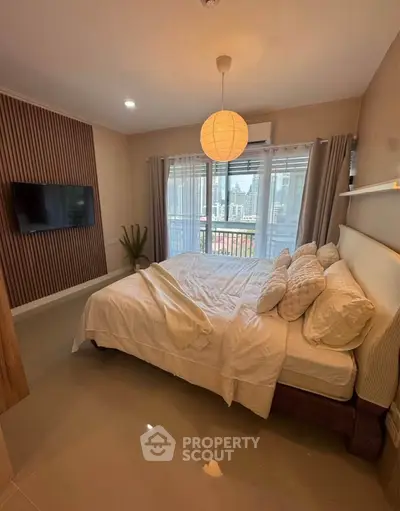 Cozy bedroom with large window and modern decor