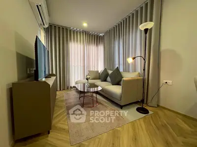 Modern living room with stylish decor, cozy sofa, and floor lamp, perfect for relaxation and entertainment.