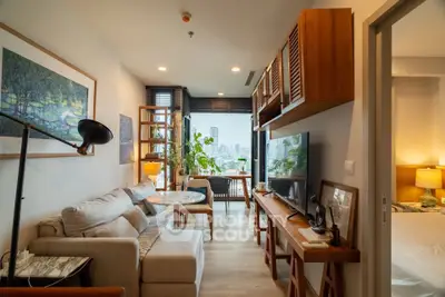 Chic modern living room with city view, cozy sofa, and stylish decor