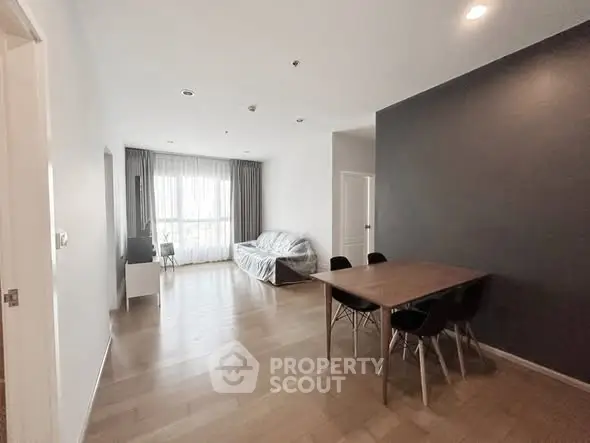 Spacious modern living room with dining area and natural light