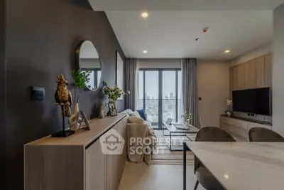 Modern living room with city view, stylish decor, and natural light.
