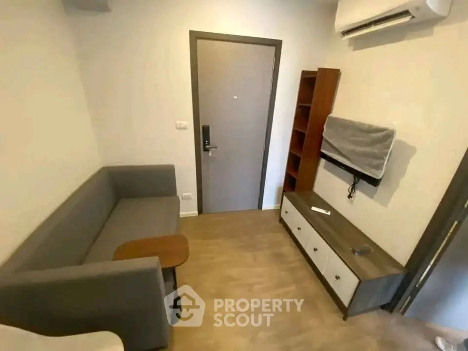 Cozy living room with modern furniture and air conditioning in a compact apartment.