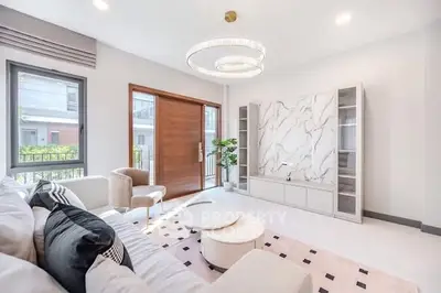 Luxurious modern living room with elegant chandelier and marble accent wall
