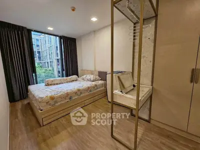 Modern bedroom with large window and stylish decor in urban apartment