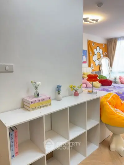 Charming bedroom with playful decor and cozy seating area, perfect for relaxation and creativity.