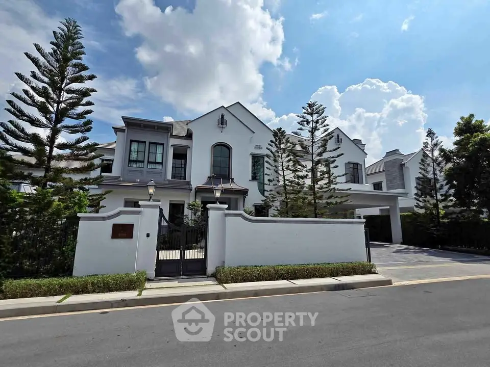 Luxurious modern villa with elegant facade and lush landscaping in a serene neighborhood.
