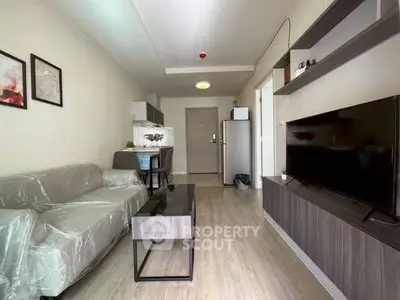 Modern living room with sleek furniture and open kitchen layout