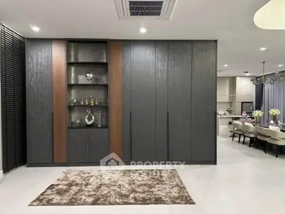 Elegant modern living space with sleek cabinetry and open kitchen layout