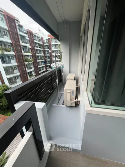 Modern apartment balcony with air conditioning units and city view