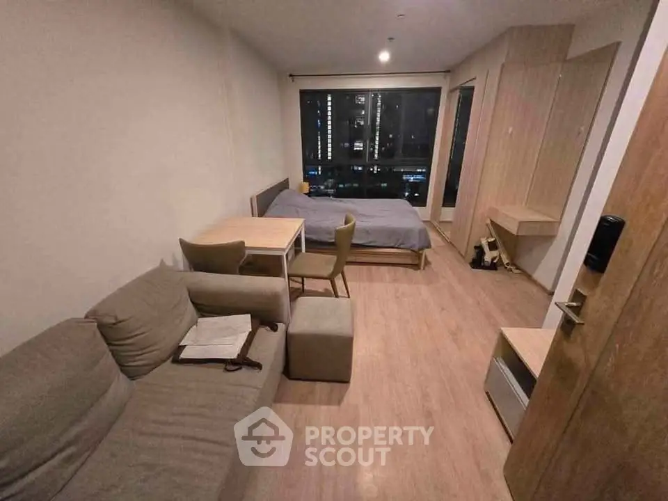 Cozy studio apartment with modern furnishings and city view, perfect for urban living.