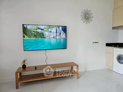 Modern living room with wall-mounted TV and sleek wooden furniture