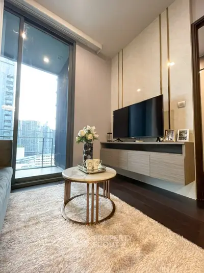 Modern living room with city view, stylish decor, and cozy ambiance in a high-rise apartment.