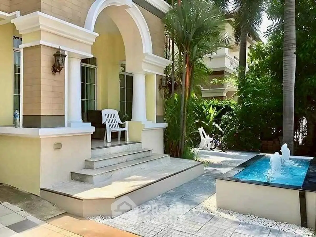 Charming villa entrance with elegant archway and serene garden fountain