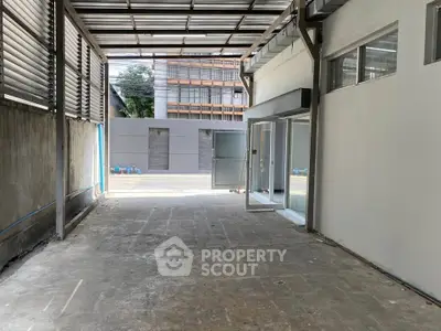 Spacious industrial warehouse with open layout and large entryway, ideal for storage or commercial use.