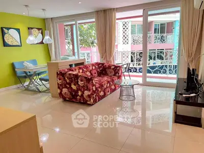 Stylish living room with vibrant decor and large windows overlooking a charming balcony.