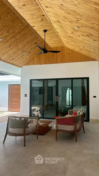 Spacious modern living room with wooden ceiling and stylish furniture