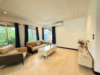 Spacious living room with modern furniture and large windows for natural light.