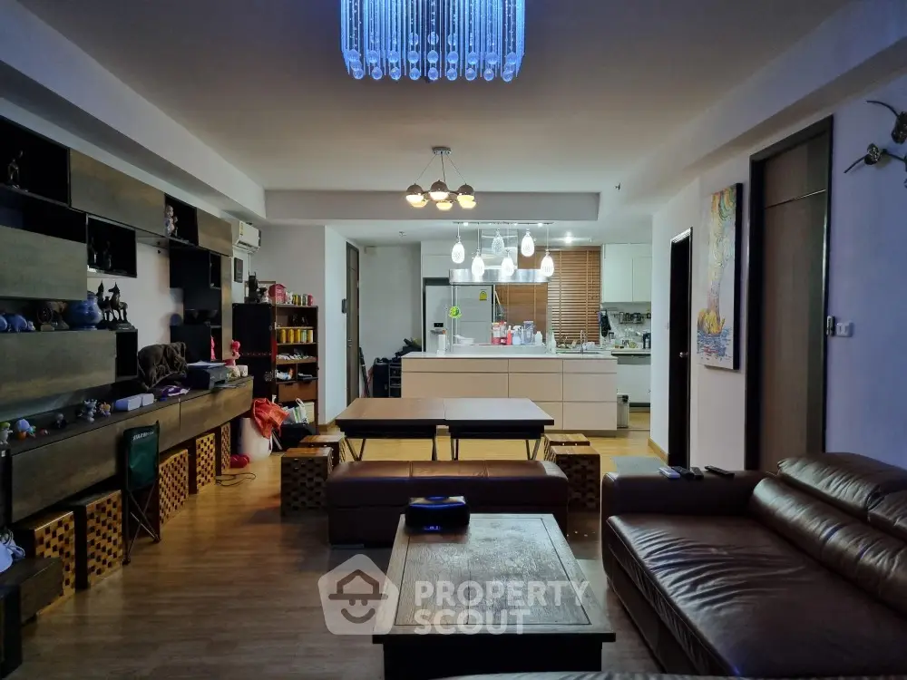 Spacious open-plan living room with modern kitchen and stylish lighting
