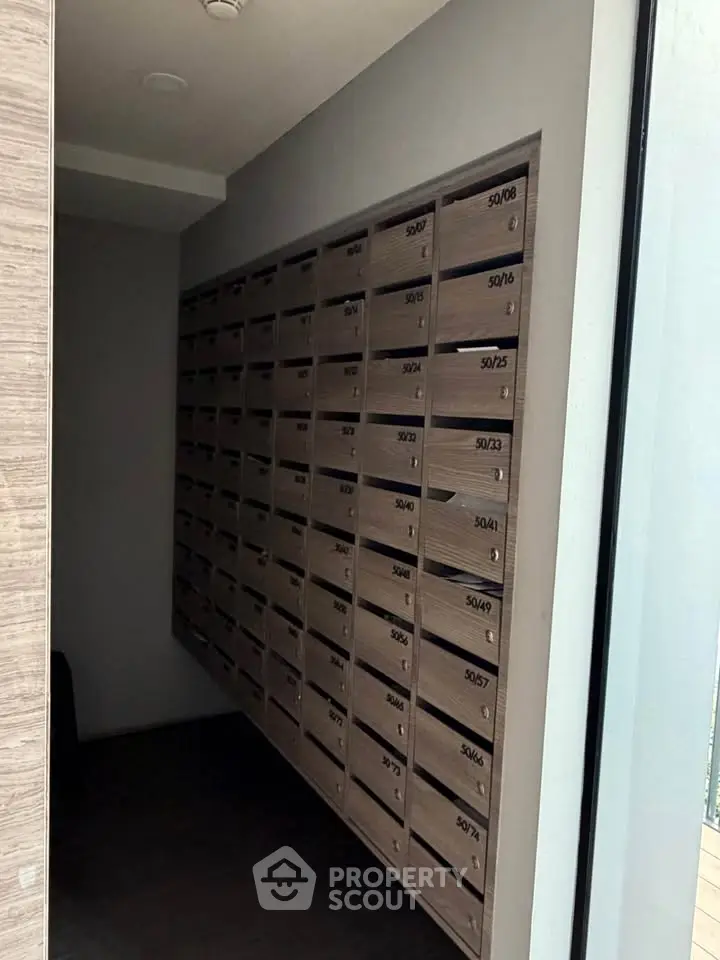 Modern apartment building mailboxes in a sleek hallway, showcasing organized and secure mail storage.
