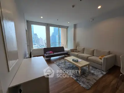 Spacious living room with modern furniture and city view, perfect for urban living.